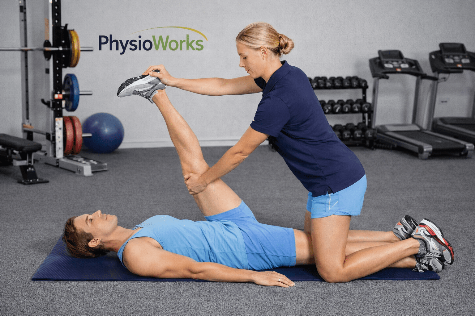 Physiotherapist guiding PNF stretching to improve hamstring flexibility