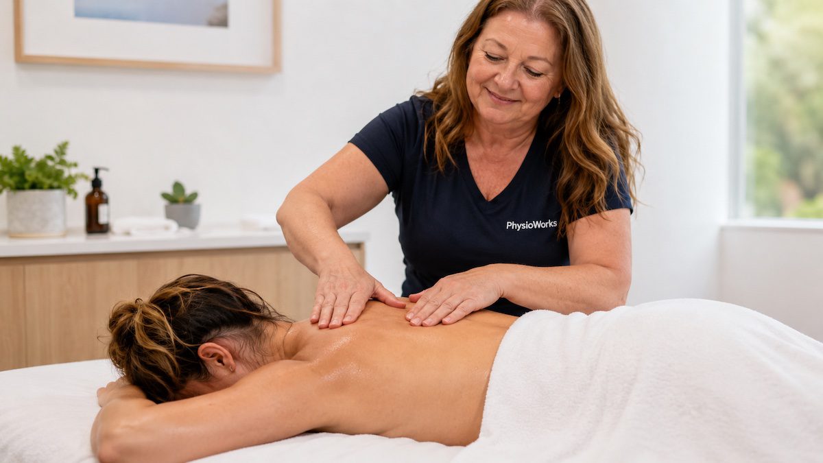 Relaxation massage therapist using gentle upper back strokes to ease stress-related tension