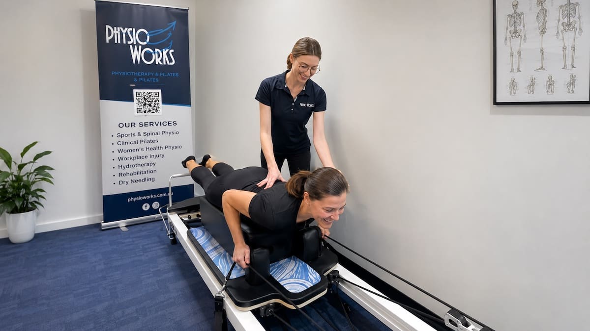 Reformer Pilates session coached by physiotherapist for trunk control