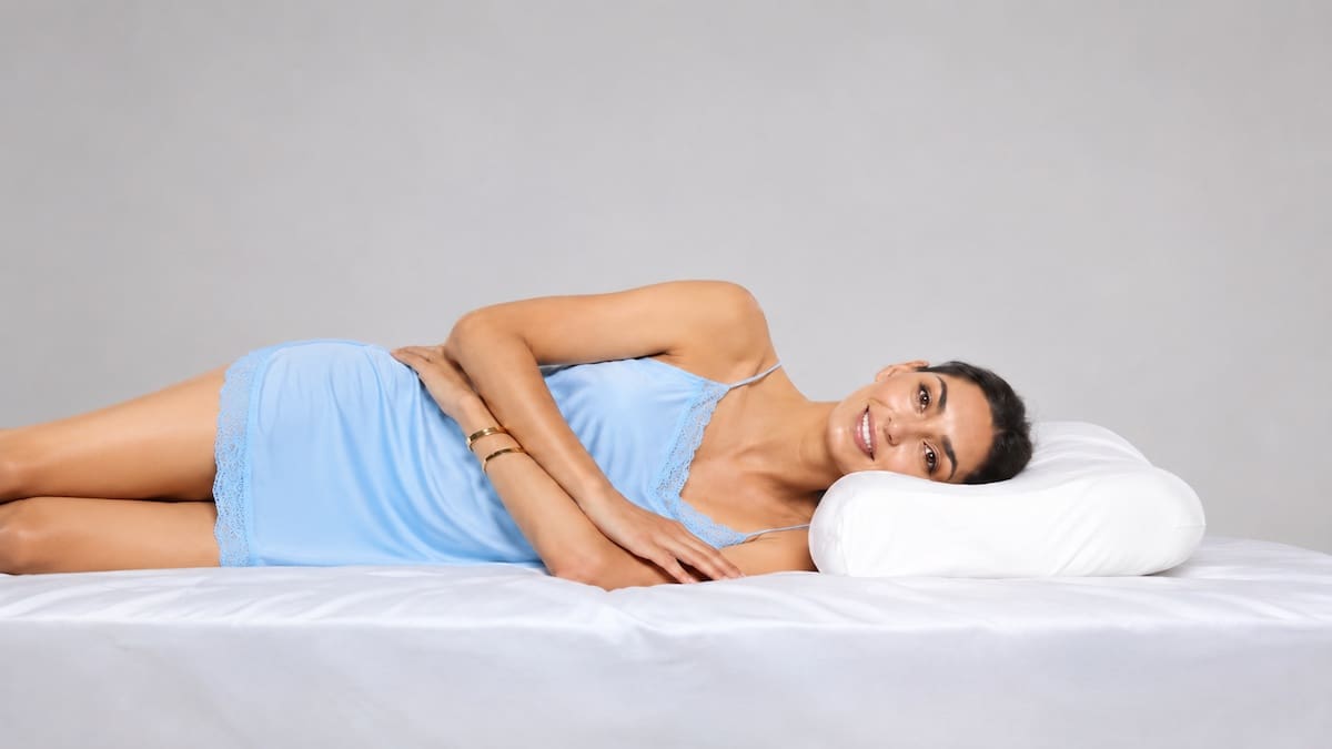 Side sleeper using pillow support for neck alignment and sleep comfort